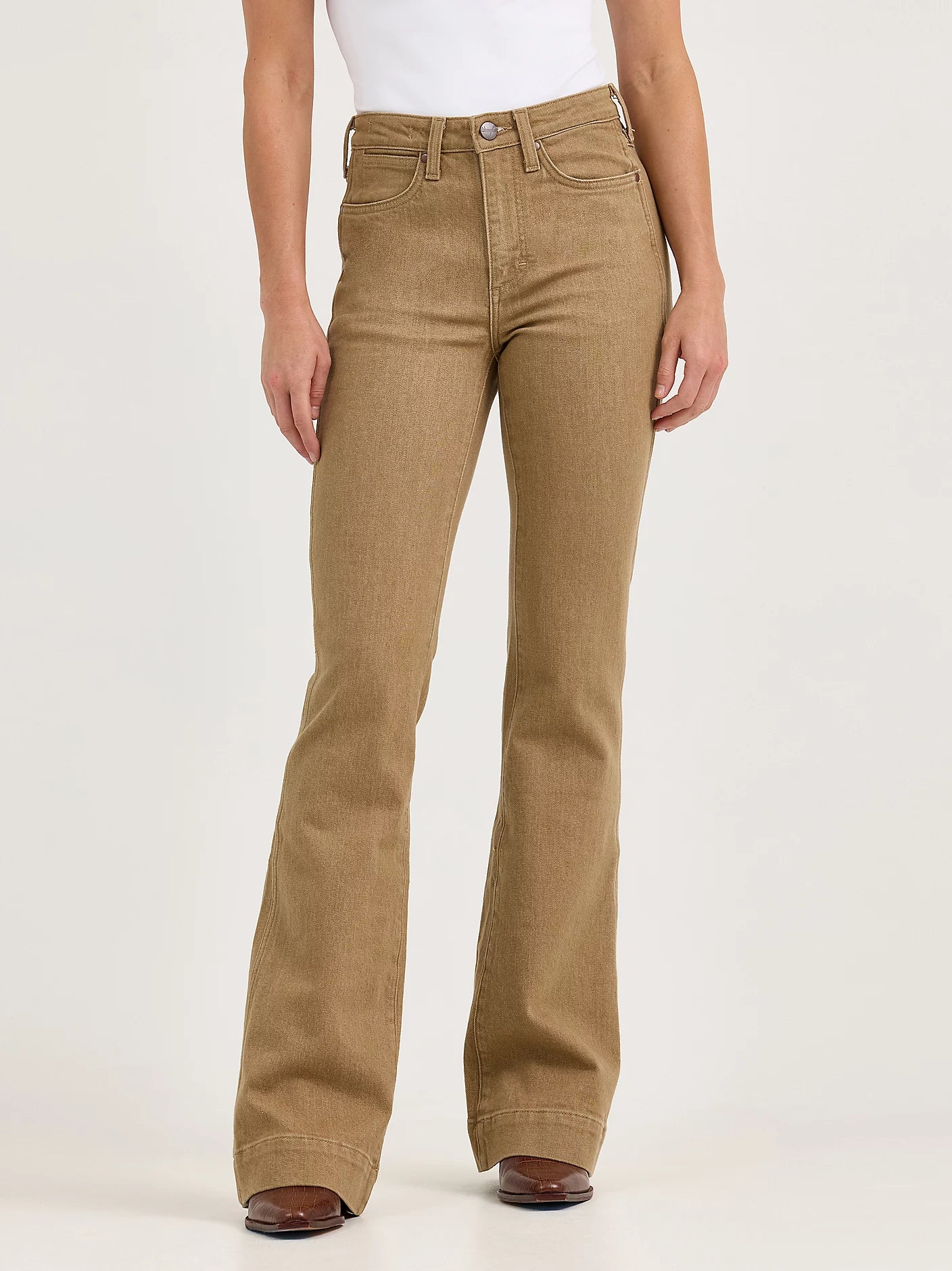 Brown flared jeans worn by a person on a white background