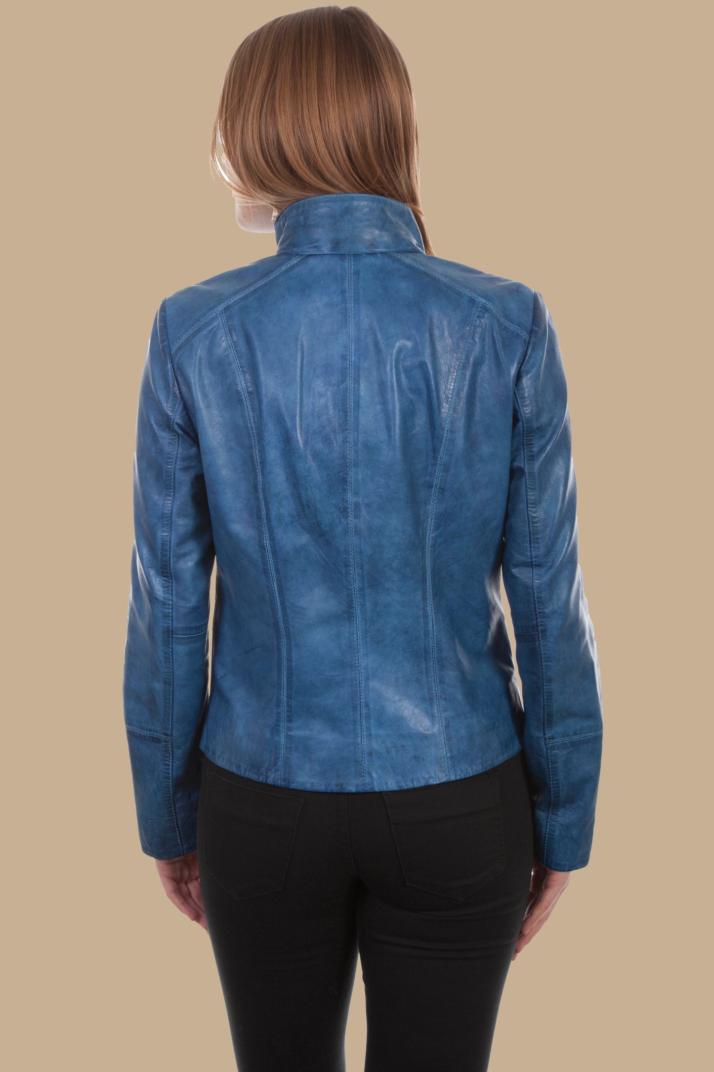Blue leather jacket worn by a person on a beige background