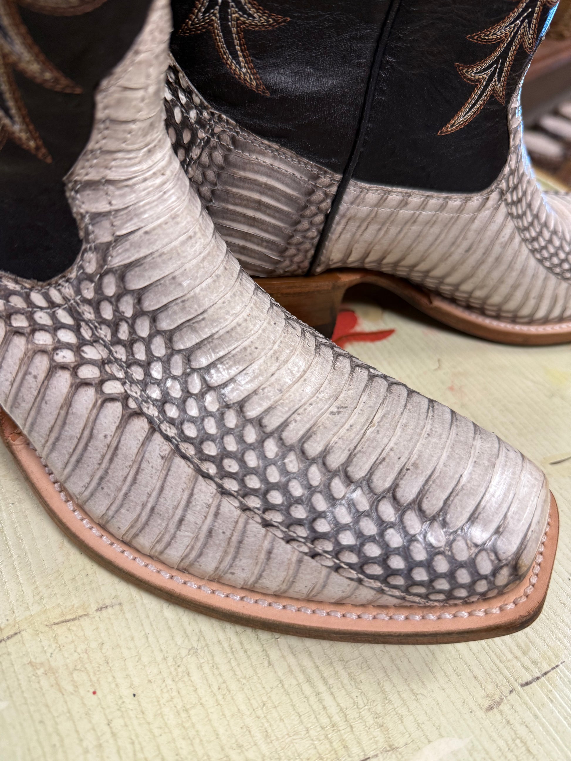 Close-up of a patterned boot with a textured sole on a light background