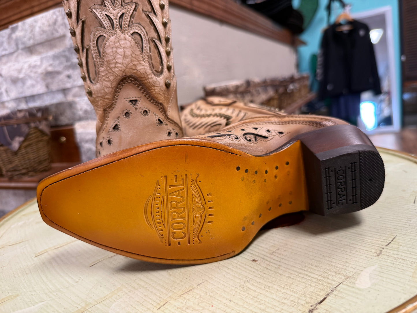 Close-up of a Corral cowboy boot sole with detailed design on a textured surface.