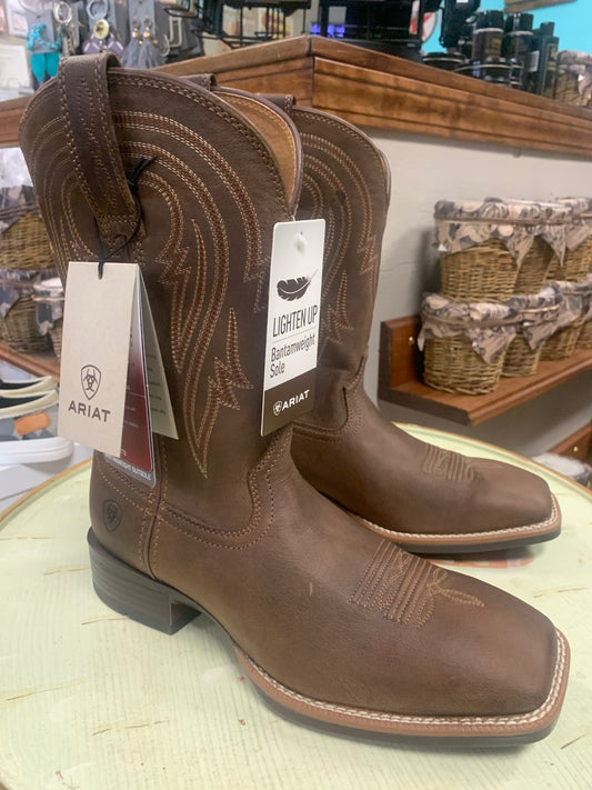 A pair of brown Plano cowboy boots with a square toe and visible brand tag on the heel.