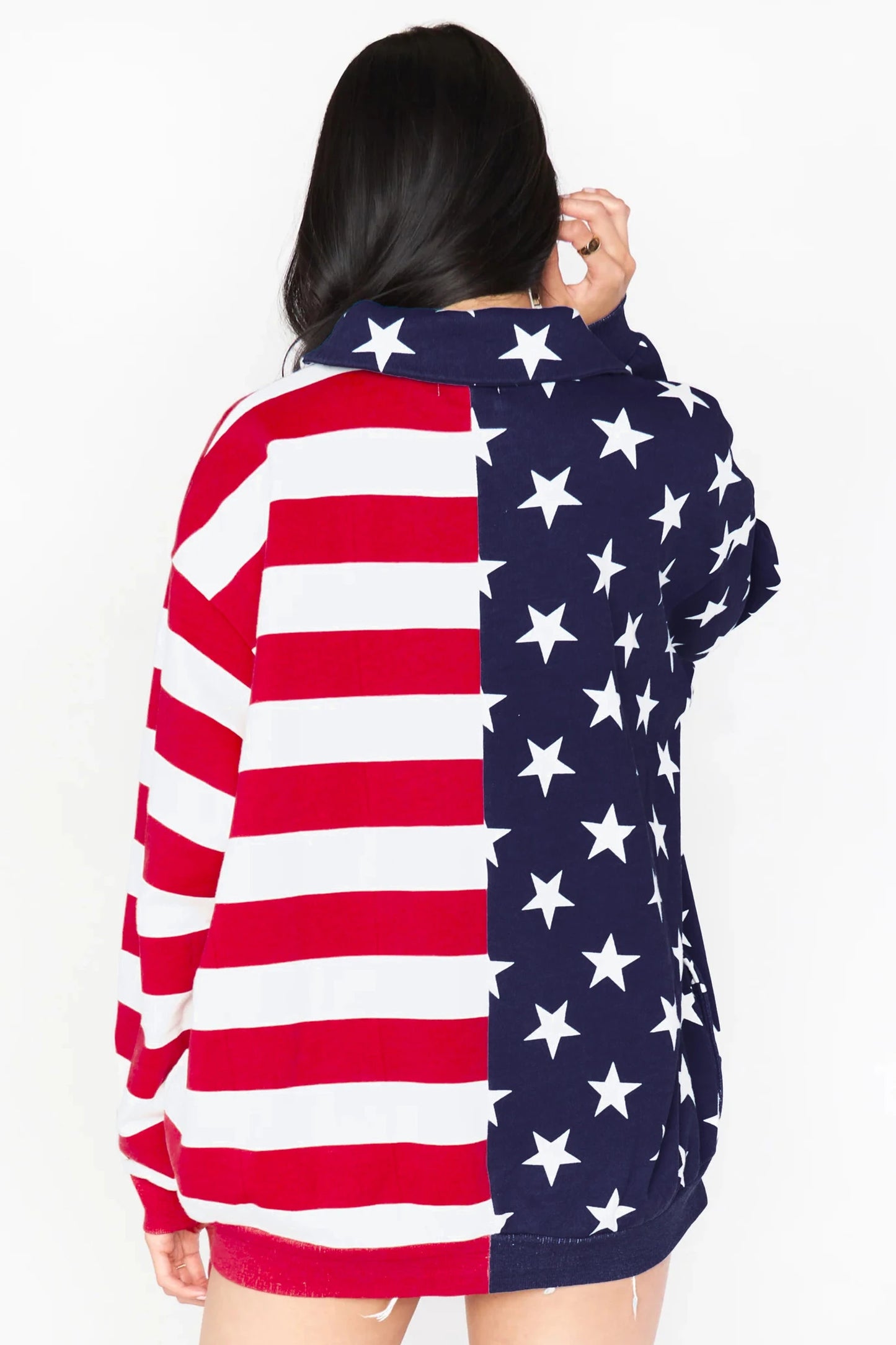 Person wearing a hoodie with an American flag design on a white background