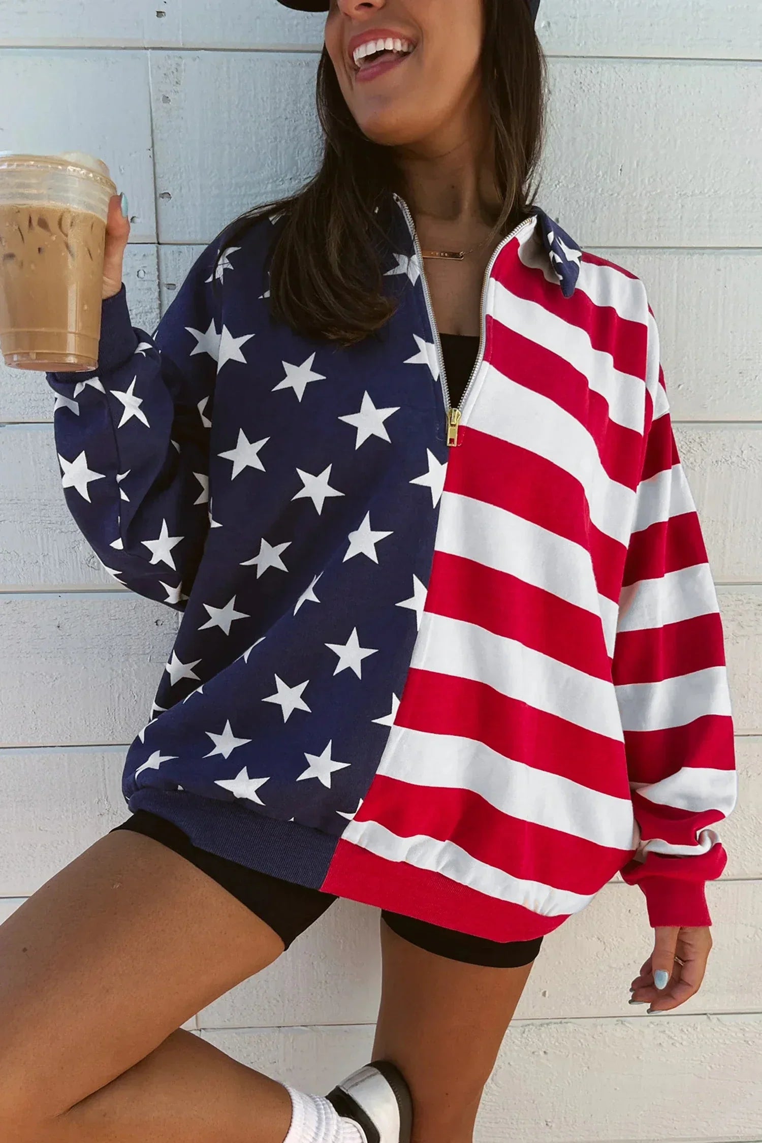 Patriotic Flad top outside on female holding ice coffee
