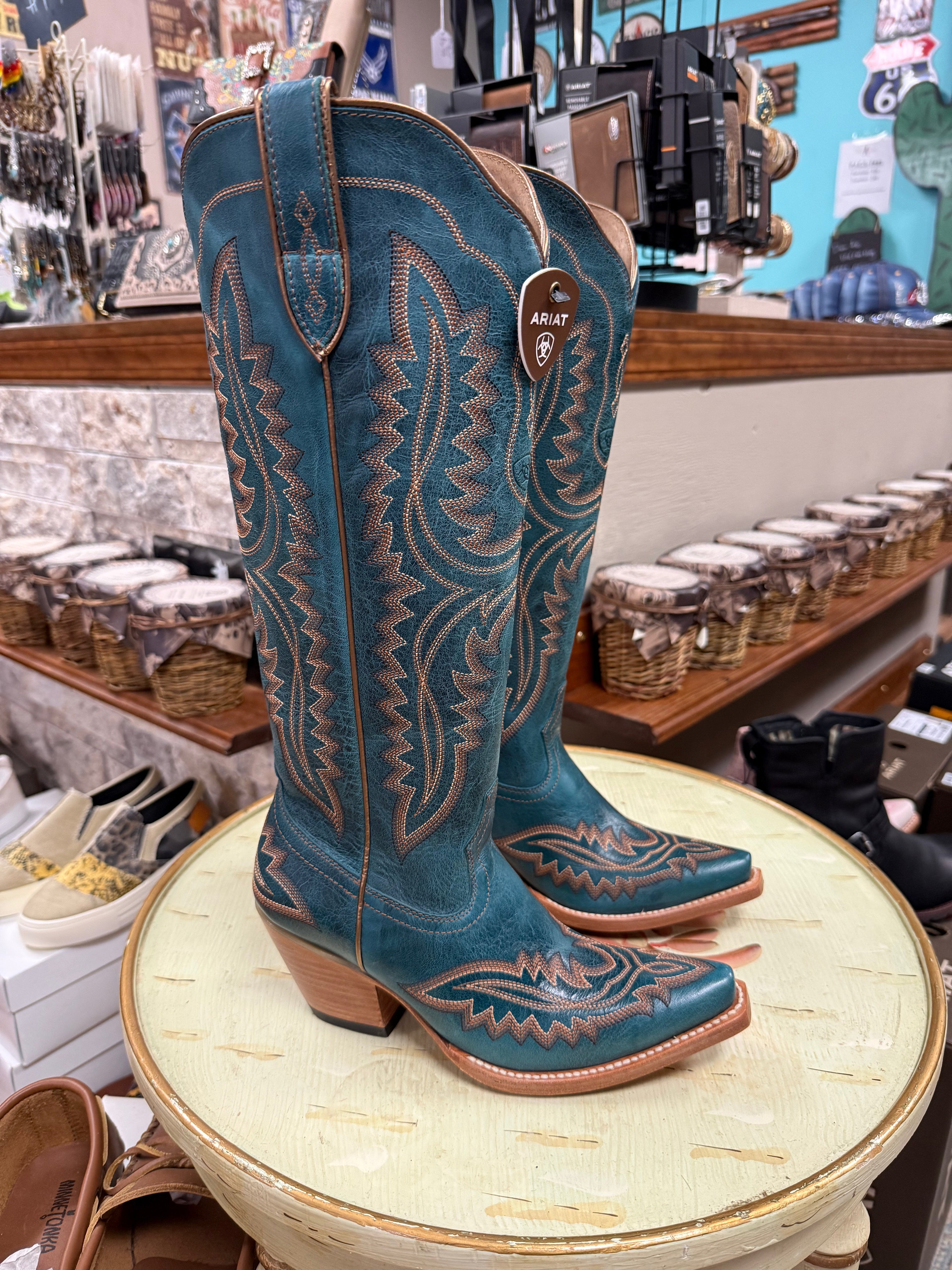 Blue cowboy boots in western storefront.