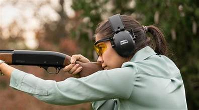 Woman wearing eye and ear protection practicing firearm safety at a shooting range in Pennsylvania