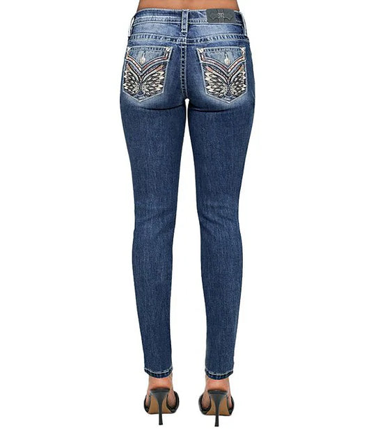 Blue jeans with decorative back pockets on a white background