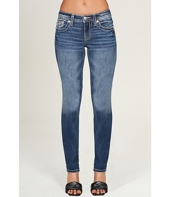 Blue jeans worn by a person on a white background