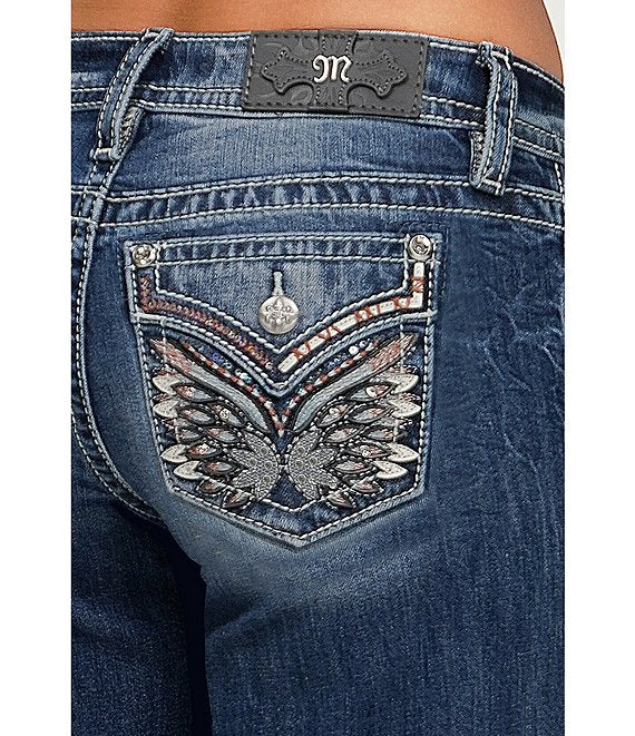Close-up of blue jeans with decorative back pocket and brand logo.
