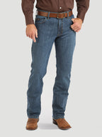 Person wearing blue jeans and brown shoes on a white background