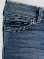 Close-up of blue jeans with stitching details on a light gray background