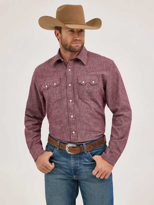 Man wearing a red plaid shirt, blue jeans, and a brown cowboy hat on a white background