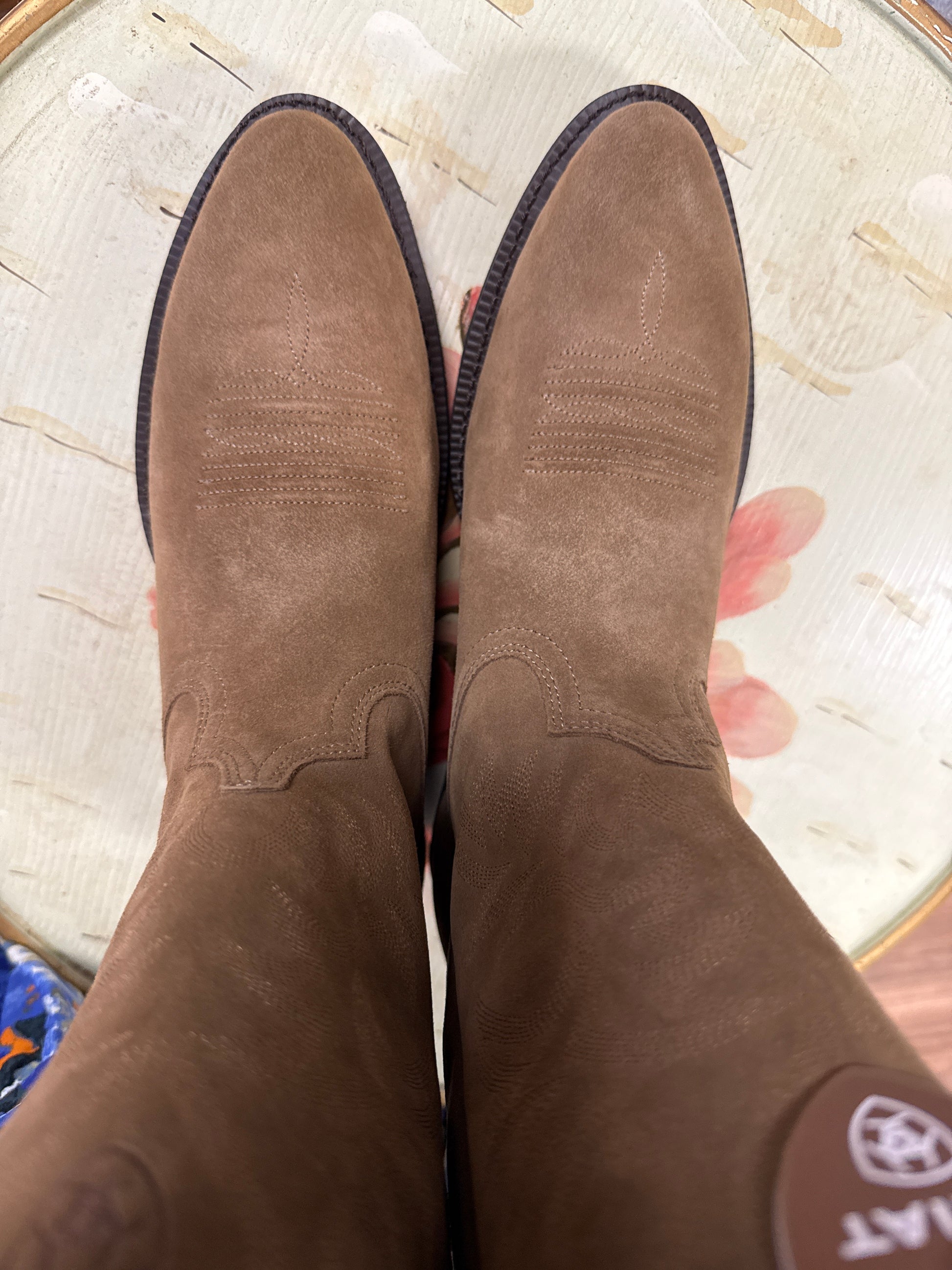 Brown suede shoes on a textured surface