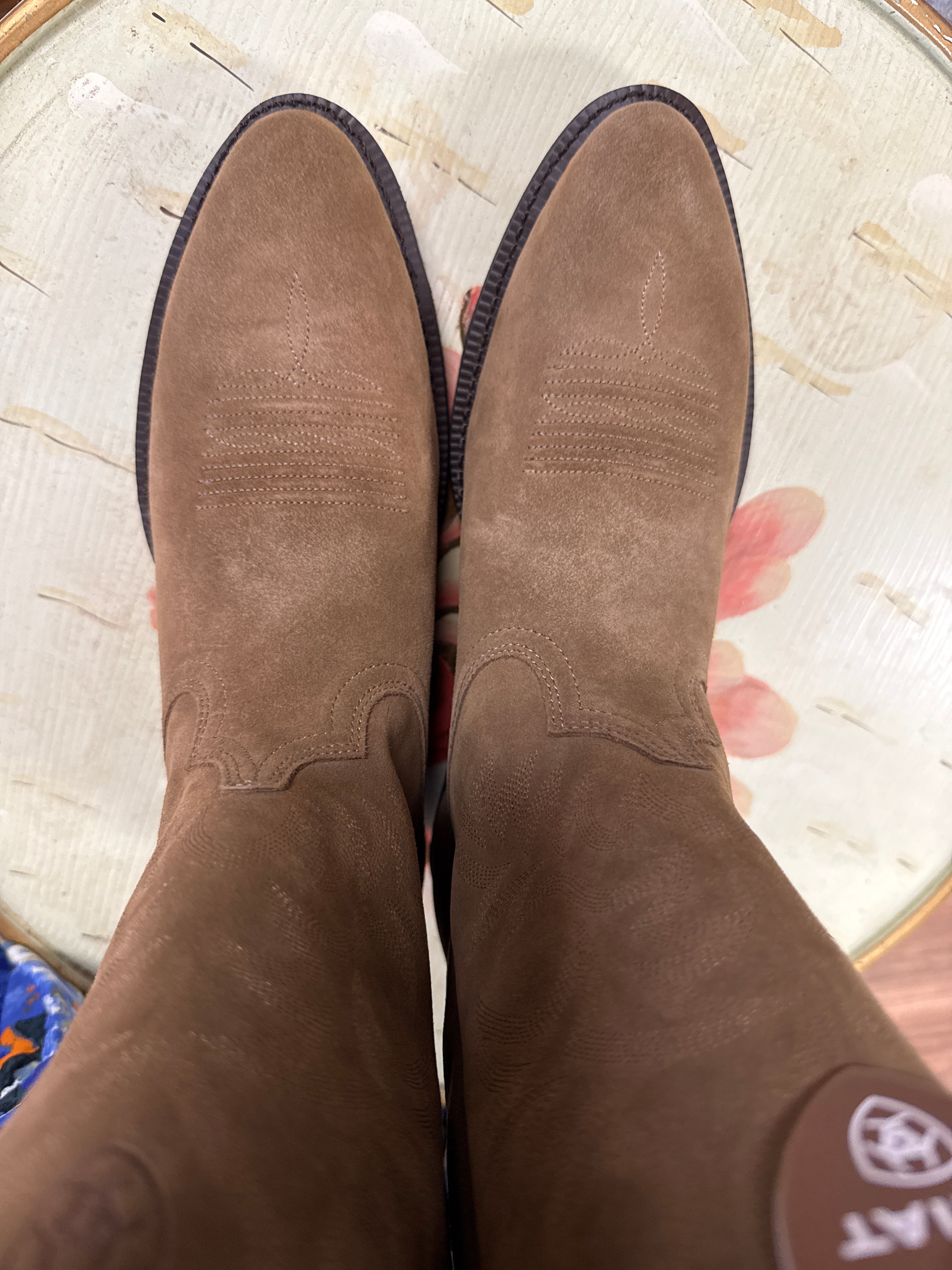 Brown suede shoes on a textured surface