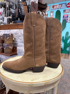 Brown suede boots on a white stool with a store interior background