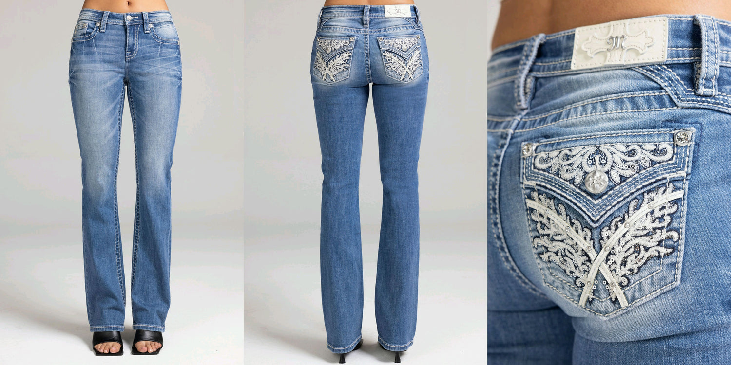 Blue jeans with decorative embellishments on a plain background
