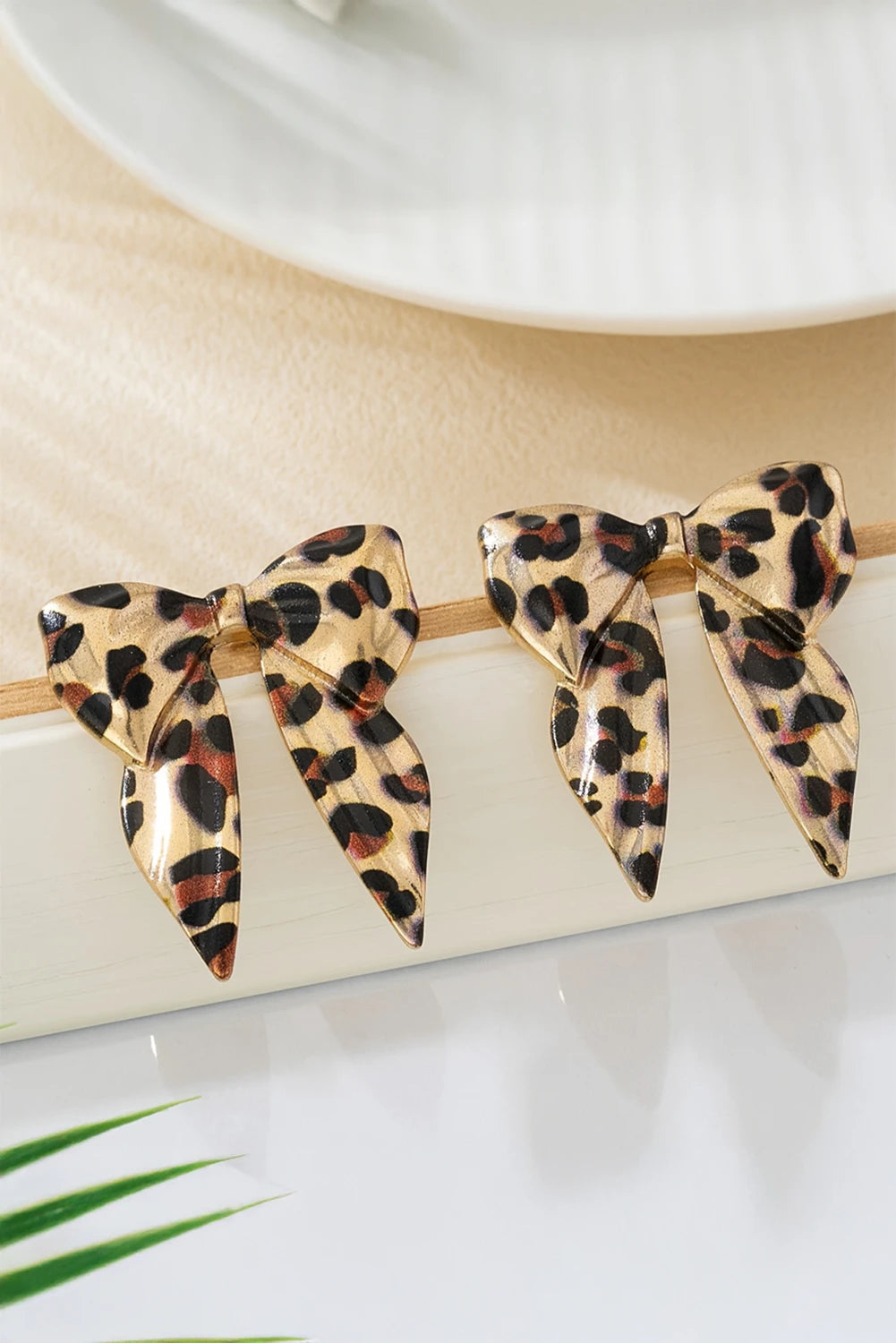 Leopard print hair bow on a white background