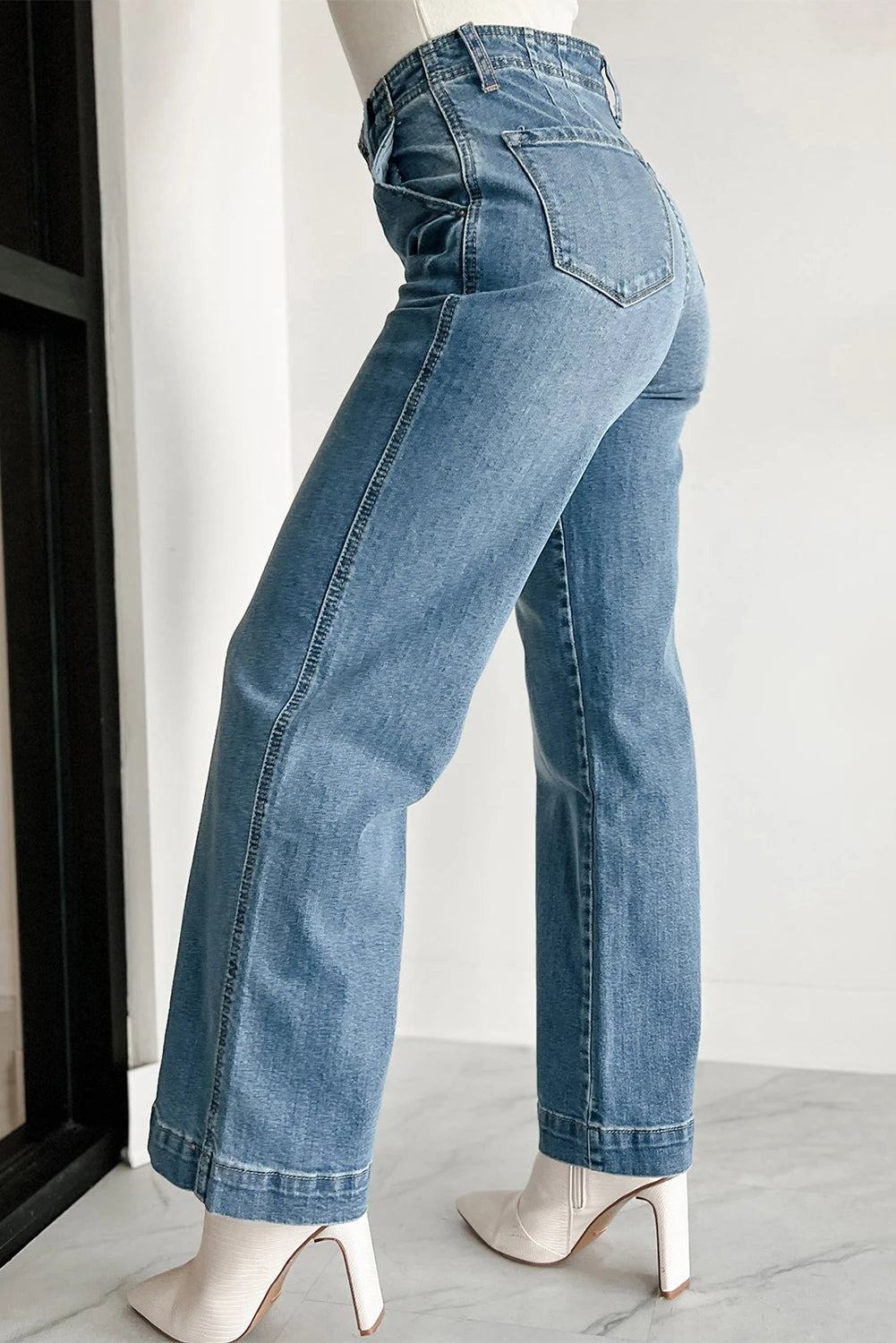 Mannequin wearing blue jeans against a white background
