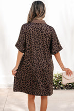 Woman wearing a leopard print dress with a plain background