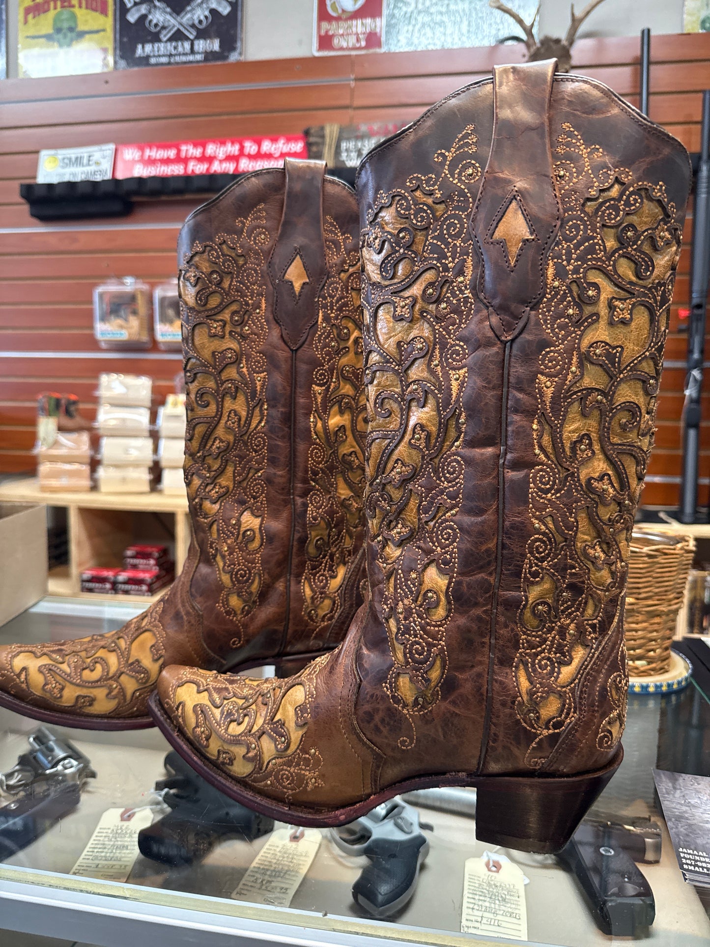 Decorative leather saddle with intricate patterns in a store setting