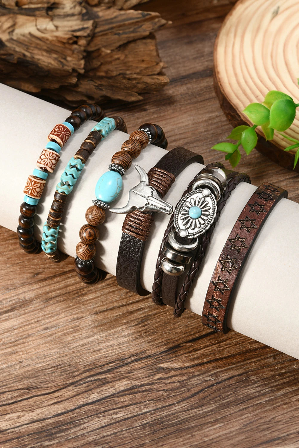 Set of bracelets with beads and leather straps on a wooden surface