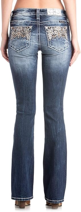 Blue jeans with embellished pockets worn by a person