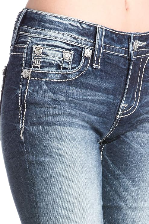 Close-up of blue jeans with decorative buttons on a white background