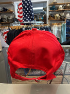 Red cap on a rack with American flags in the background