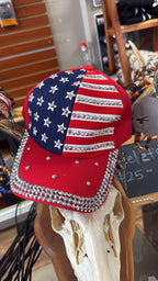 Cap with American flag design and rhinestones on a mannequin head.