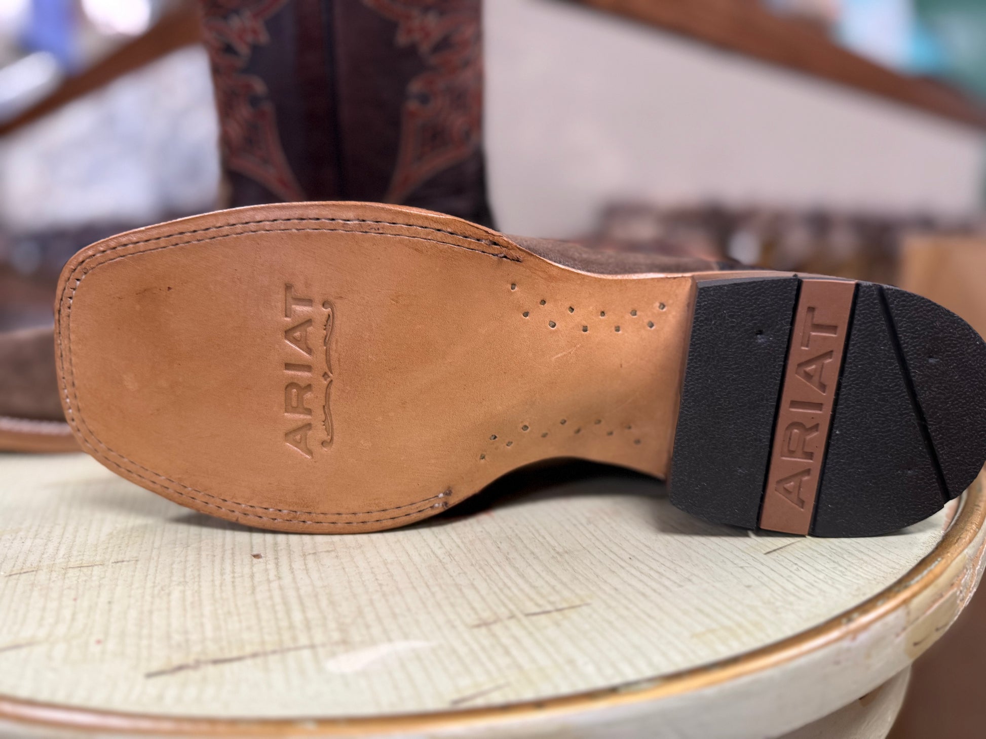 Close-up of Ariat logo on the sole of a boot
