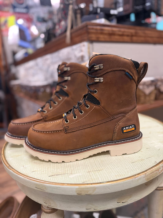 Brown leather boots with visible Ariat logo on a wooden stool.
