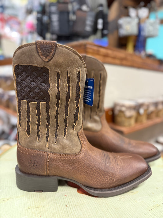 Brown leather boots with a distinctive pattern on a store shelf.