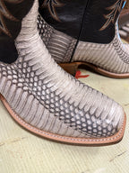 Close-up of a patterned boot with a textured sole on a light background