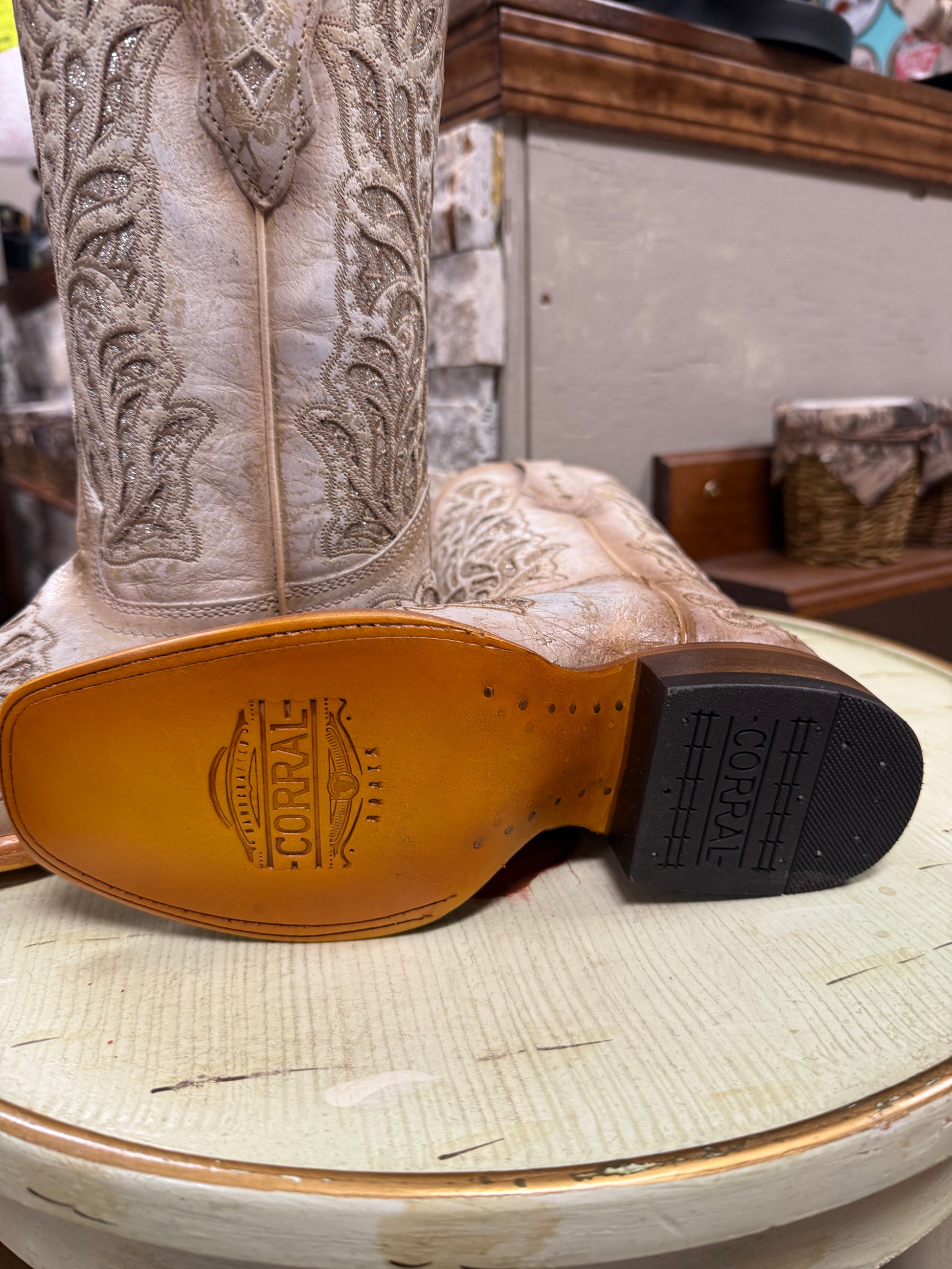 Close-up of a Corral cowboy boot with intricate detailing on a light surface.