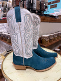 Pair of white and blue cowboy boots on a stool in a store setting.