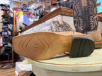 Close-up of a shoe sole with 'Teksled' branding in a store setting.
