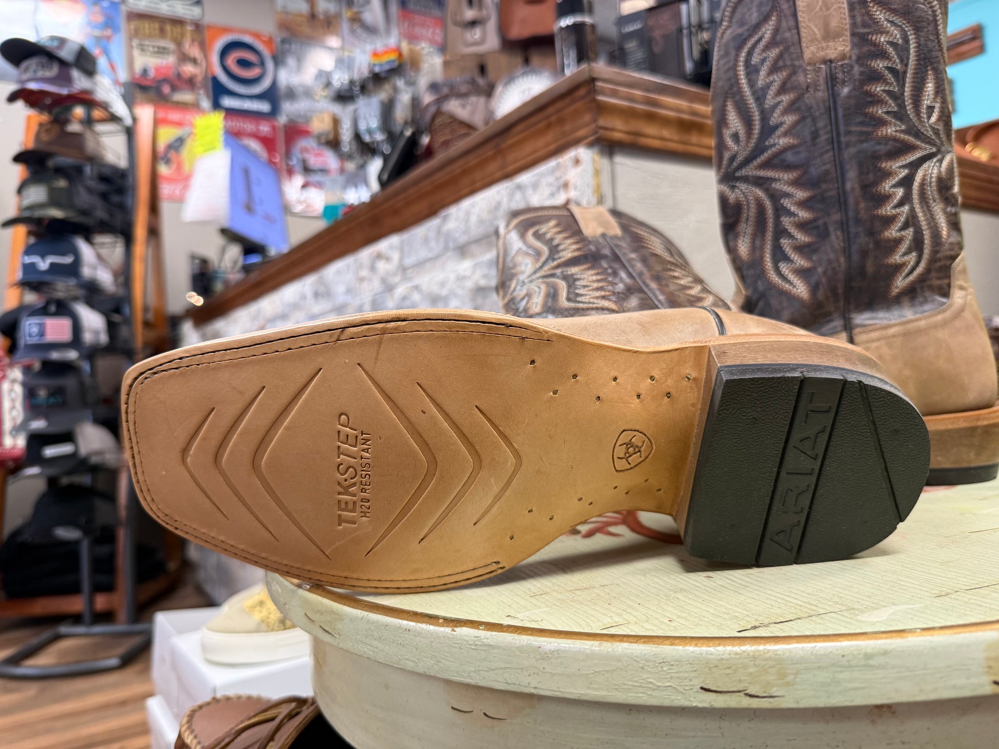 Close-up of a shoe sole with 'Teksled' branding in a store setting.