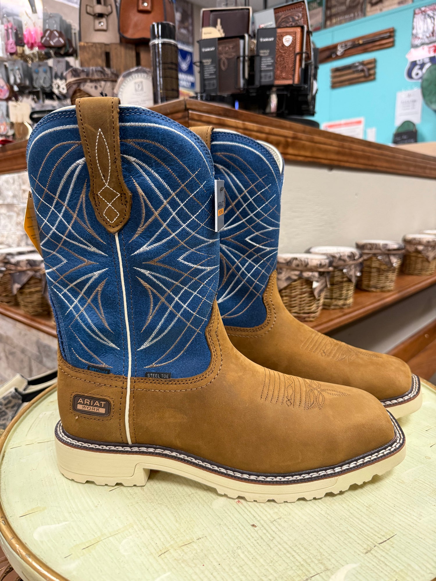 Pair of brown embroidered cowboy boots on a wooden surface with a blurred background.