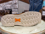 Close-up of a shoe sole with a brand logo on a textured surface