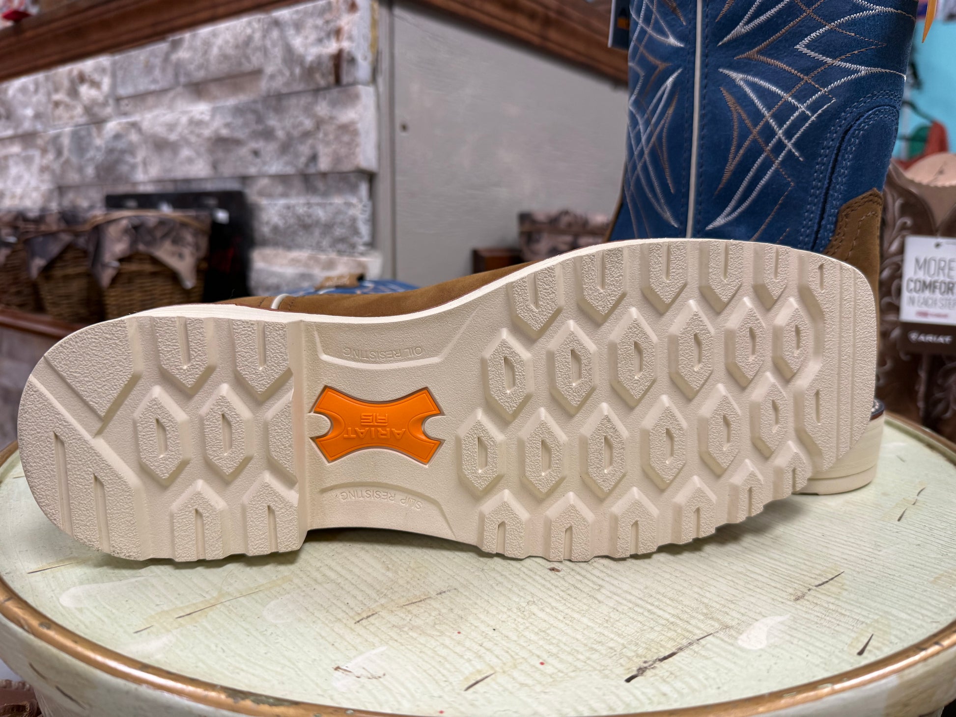 Close-up of a shoe sole with a brand logo on a textured surface