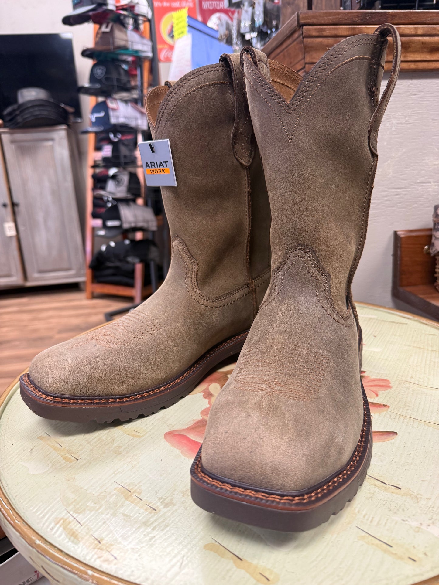 Pair of brown boots on a stool in a store setting