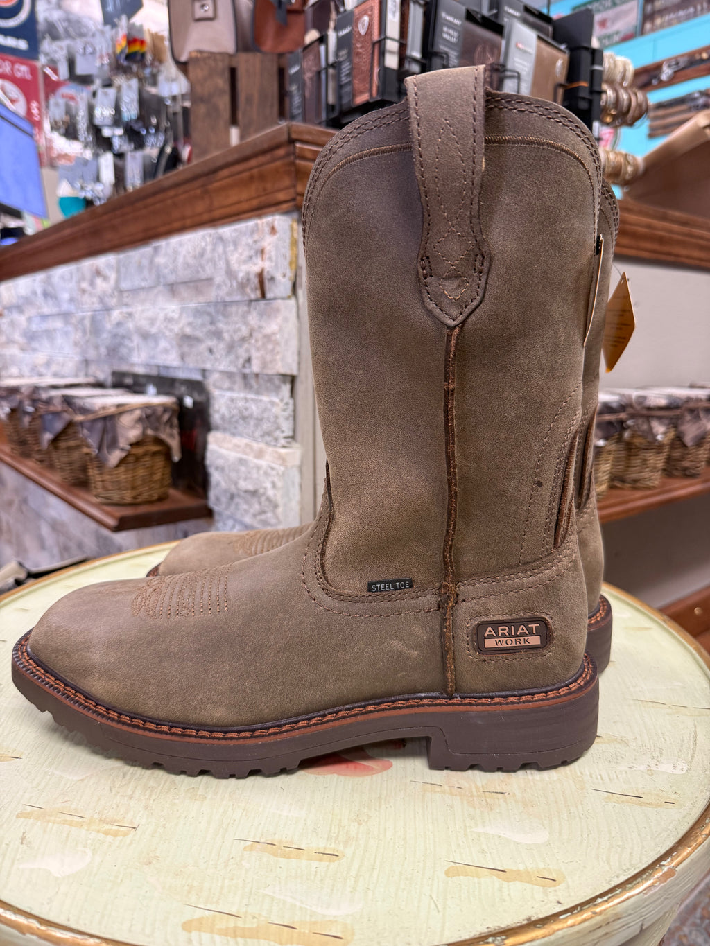 Brown work boot on a wooden surface with a store interior background