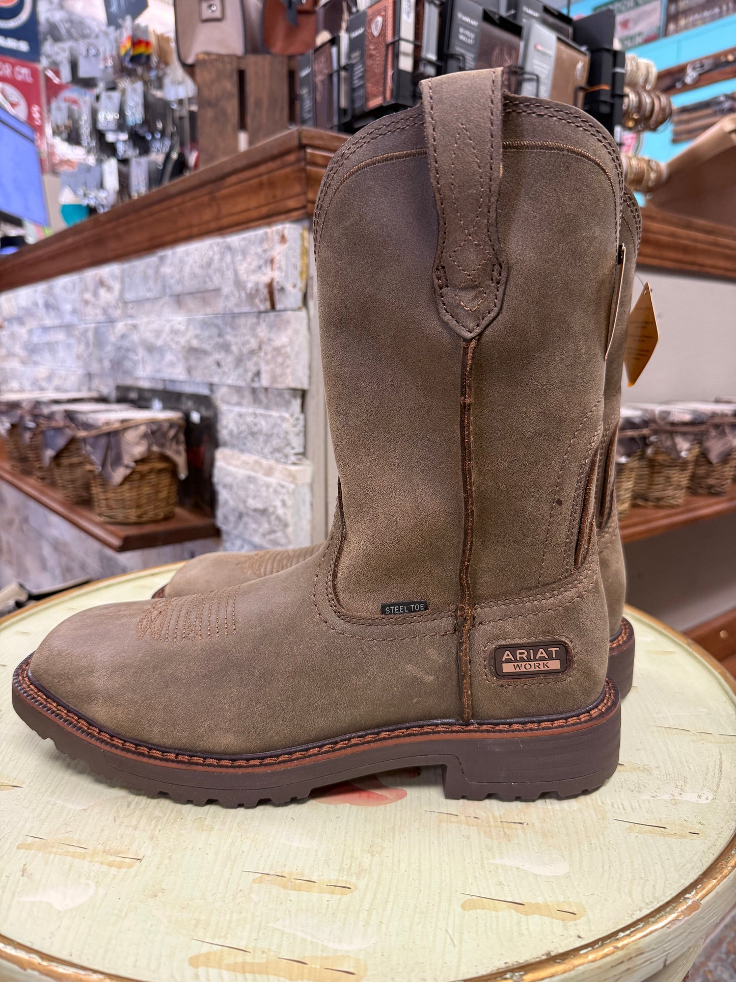 Brown work boot on a wooden surface with a store interior background