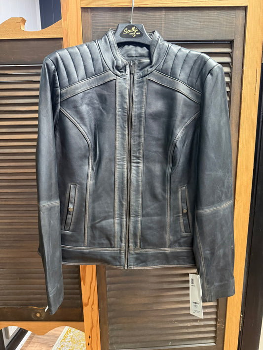 Black leather jacket on a hanger with a visible brand tag against a wooden background