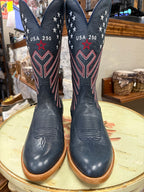 Pair of navy blue cowboy boots with red and white star patterns on a round table.