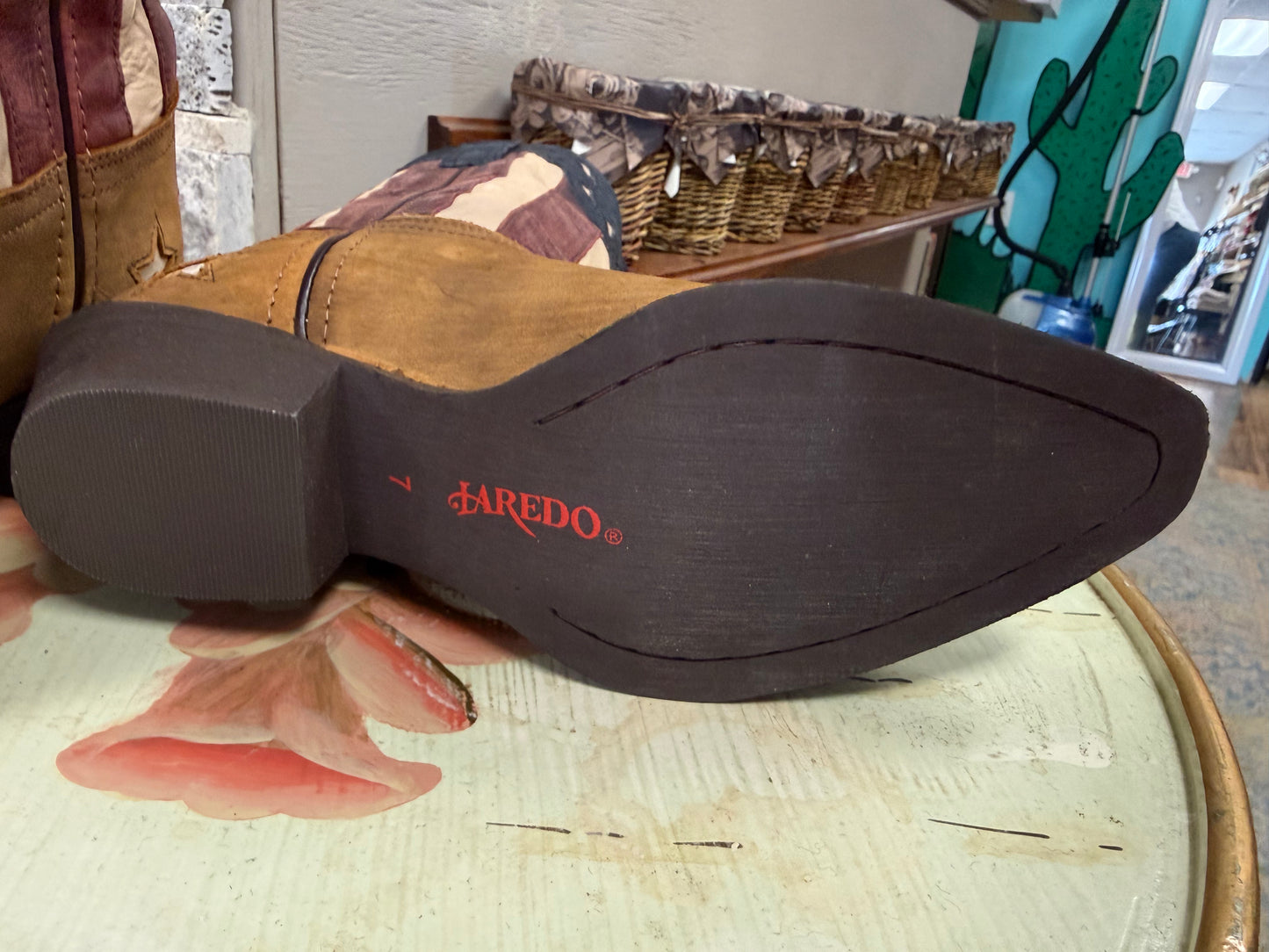 Close-up of a cowboy boot sole with 'FARERO' branding on a patterned surface.