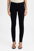 Person wearing black jeans on a white background