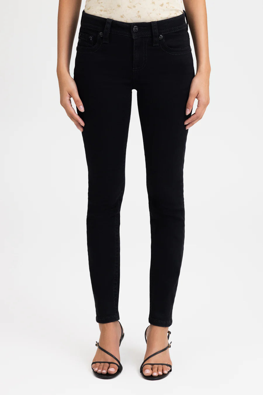 Person wearing black jeans on a white background