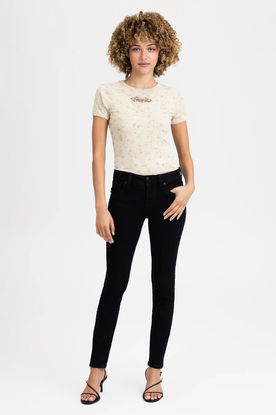Woman wearing a white t-shirt and black pants on a white background
