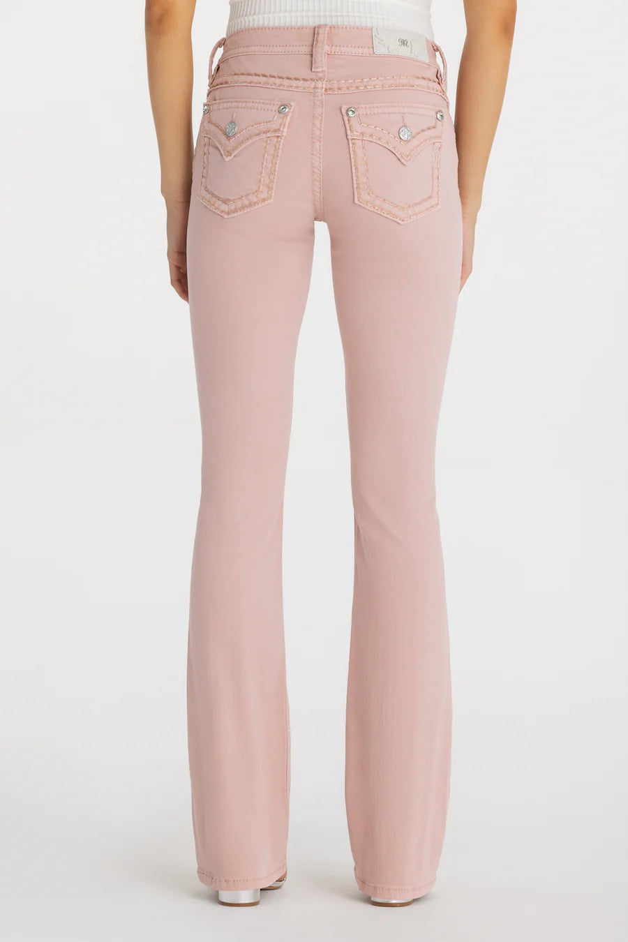 Pink jeans worn by a person on a white background