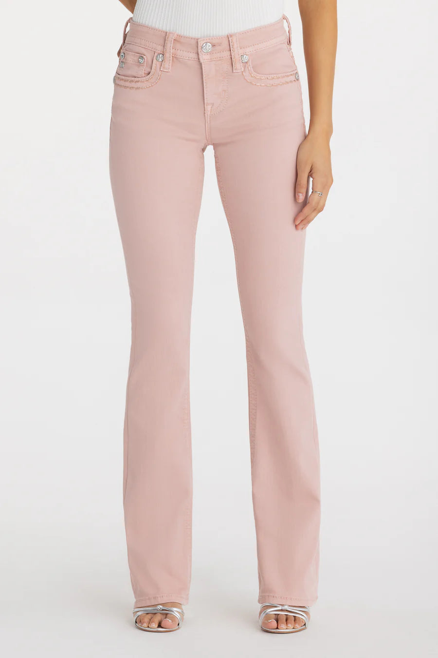 Pink jeans worn by a person on a white background